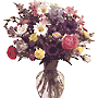 vase arrangement with flowers such as Daisies, Carnations, Monte Casino, Alstroemeria, and more.