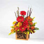 fall arrangement with autumn colored flowers such as mini Carnations, Daisy Pompons, Mini Lilies, Aster and Lilies.