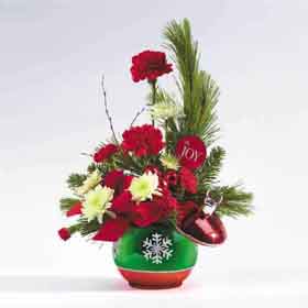 holiday floral arrangement in a fine crafted ceramic 		ornament